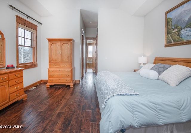 bedroom featuring dark wood finished floors and baseboards