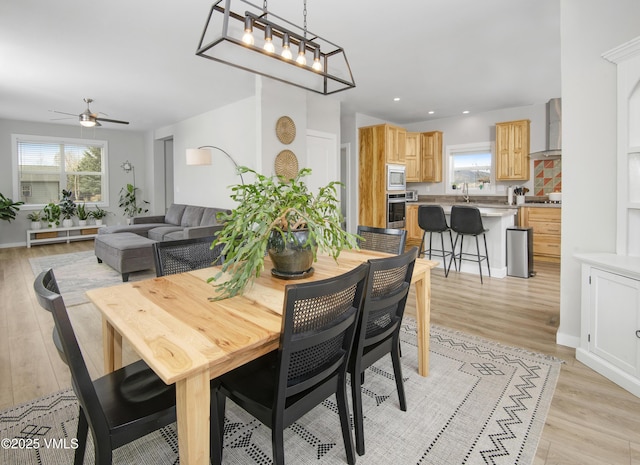 dining space with recessed lighting, a ceiling fan, and light wood-style flooring