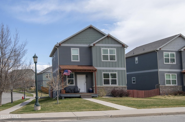 craftsman-style home with a porch, board and batten siding, and a front yard