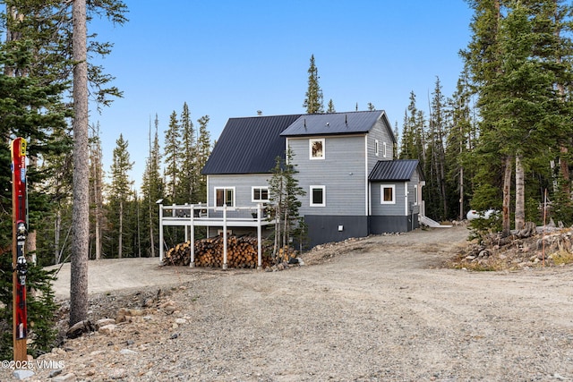 408 El Lobo Ln, Fairplay, CO 80440 - rear view of house with a metal roof, dirt driveway, and a wooden deck