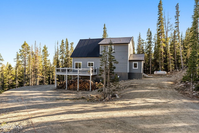408 El Lobo Ln, Fairplay, CO 80440 - view of front of home with a metal roof, a deck, and dirt driveway
