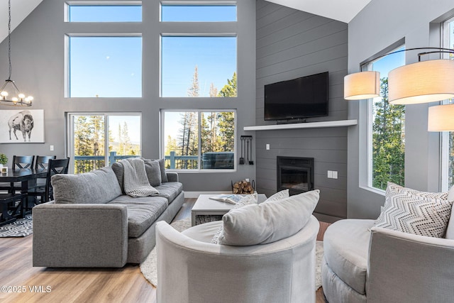 408 El Lobo Ln, Fairplay, CO 80440 - living room with high vaulted ceiling, wood finished floors, a fireplace, and a chandelier