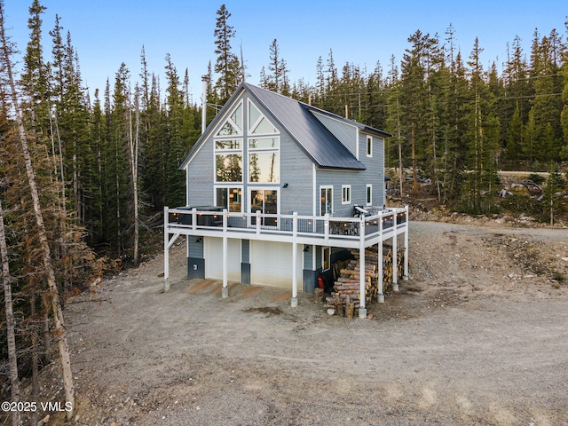 408 El Lobo Ln, Fairplay, CO 80440 - back of house with a metal roof, a wooden deck, a wooded view, and driveway