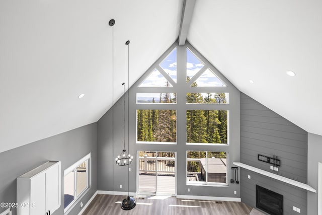 408 El Lobo Ln, Fairplay, CO 80440 - living area with high vaulted ceiling, beam ceiling, wood finished floors, a fireplace, and a chandelier
