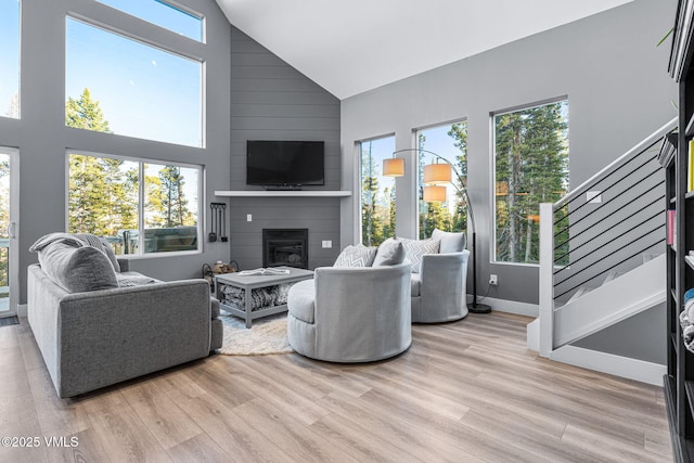 408 El Lobo Ln, Fairplay, CO 80440 - living room with high vaulted ceiling, stairway, light wood finished floors, and a fireplace