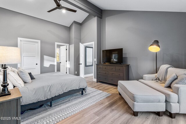 408 El Lobo Ln, Fairplay, CO 80440 - bedroom with beamed ceiling, light wood-type flooring, high vaulted ceiling, a ceiling fan, and connected bathroom