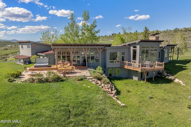 6306 Bellyache Ridge Rd, Wolcott, CO 81655 - back of house featuring a lawn, a wooden deck, a patio, and a chimney
