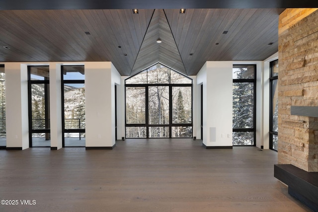 366 Forest Rd, Vail, CO 81657 - unfurnished living room with wooden ceiling, baseboards, lofted ceiling, wood finished floors, and floor to ceiling windows