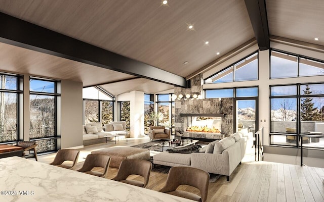 366 Forest Rd, Vail, CO 81657 - living area with wood finished floors, a multi sided fireplace, and plenty of natural light