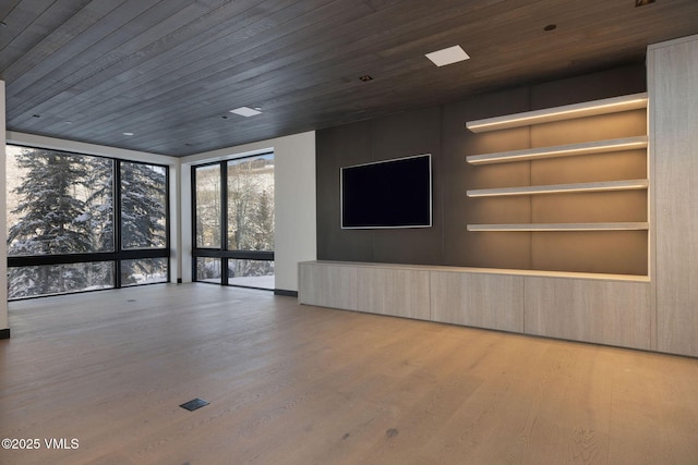 366 Forest Rd, Vail, CO 81657 - unfurnished living room featuring wood finished floors, wooden ceiling, built in features, and expansive windows