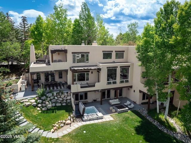 670 Winslow Rd, Edwards, CO 81632 - rear view of property with outdoor lounge area, stucco siding, a patio area, and an outdoor pool
