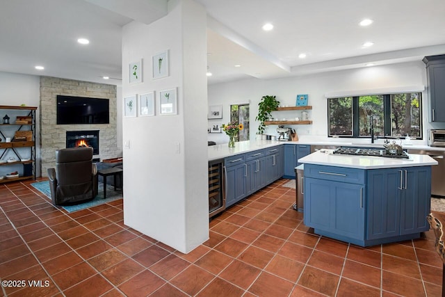 670 Winslow Rd, Edwards, CO 81632 - kitchen featuring wine cooler, blue cabinetry, stainless steel gas stovetop, light countertops, and recessed lighting