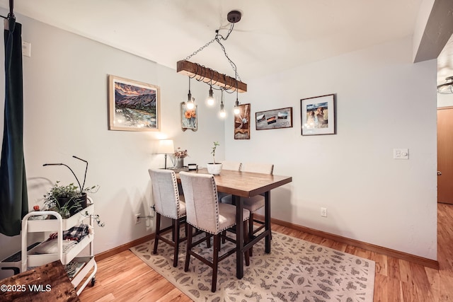 dining space with light hardwood / wood-style flooring