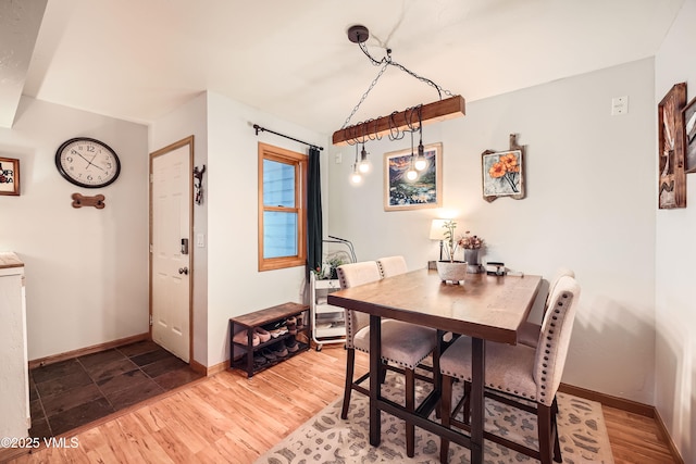 dining space with hardwood / wood-style flooring