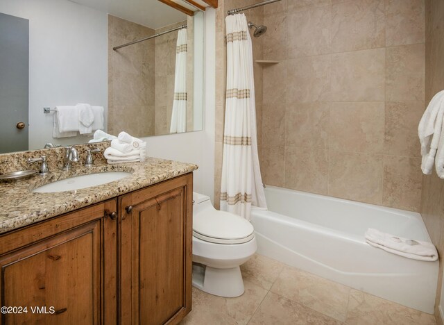 full bathroom featuring shower / tub combo with curtain, vanity, tile patterned floors, and toilet