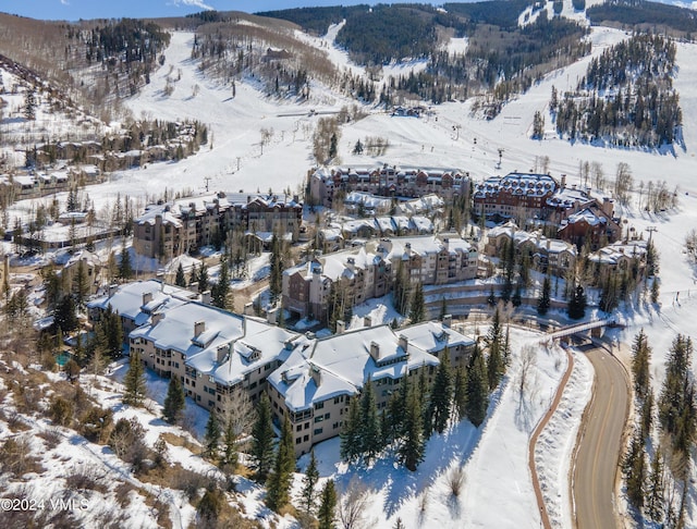 snowy aerial view with a mountain view