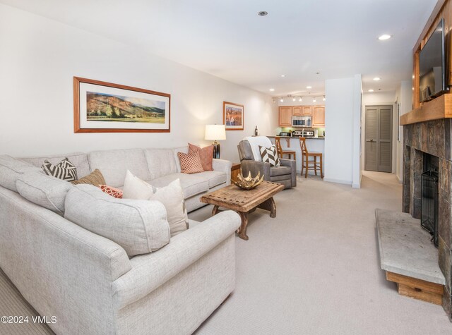 311 Offerson Rd Unit 329, Beaver Creek, CO 81620 - living room featuring a fireplace with raised hearth, light carpet, and recessed lighting