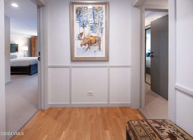 311 Offerson Rd Unit 329, Beaver Creek, CO 81620 - hallway with a decorative wall, light wood-type flooring, and a wainscoted wall