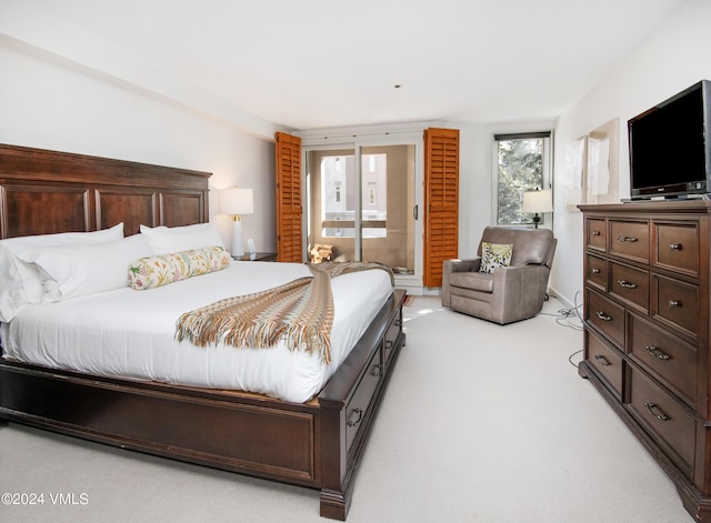 bedroom featuring light colored carpet