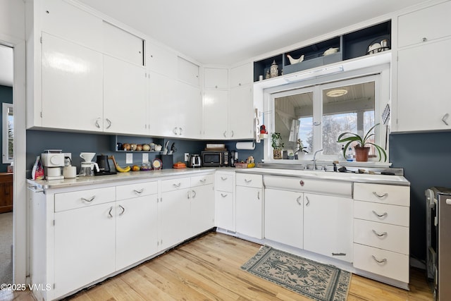 618 W Chestnut St, Leadville, CO 80461 - kitchen featuring light countertops, white cabinetry, a sink, and light wood finished floors