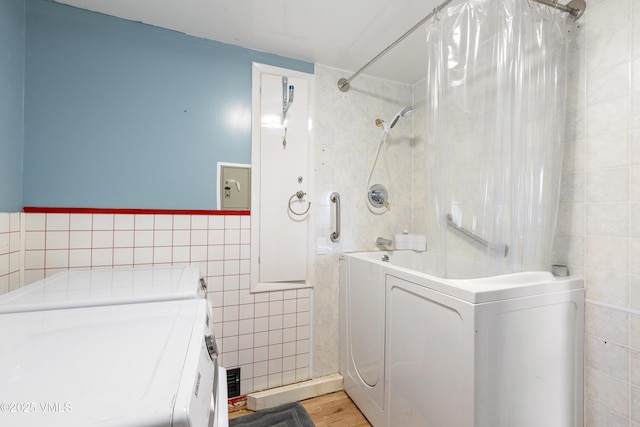 618 W Chestnut St, Leadville, CO 80461 - full bathroom with tile walls, wood finished floors, and independent washer and dryer