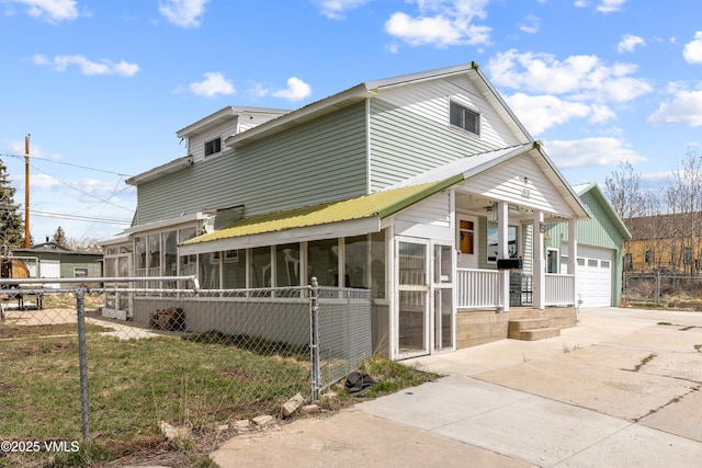 618 W Chestnut St, Leadville, CO 80461 - view of front facade featuring a porch, fence, a sunroom, and concrete driveway