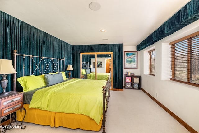 carpeted bedroom featuring baseboards and access to exterior