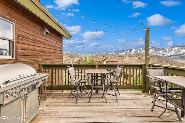 wooden terrace with a mountain view and a grill