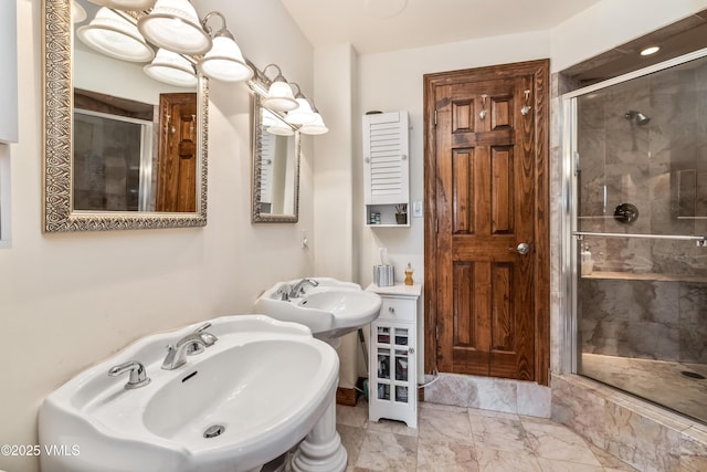 bathroom featuring marble finish floor and a shower stall
