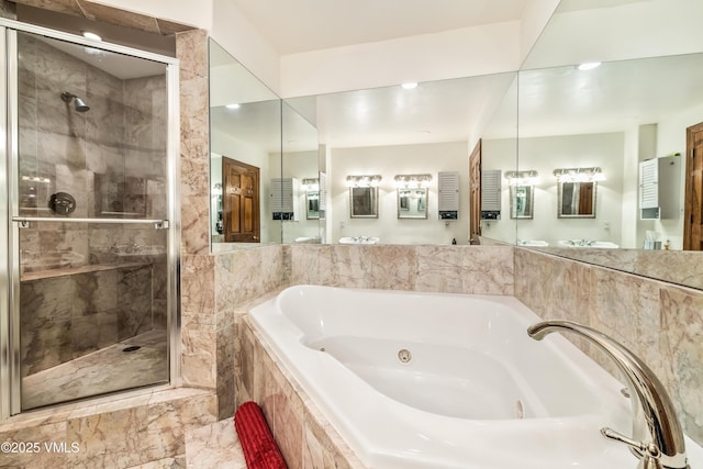 full bath featuring a tub with jets, a shower stall, and vanity