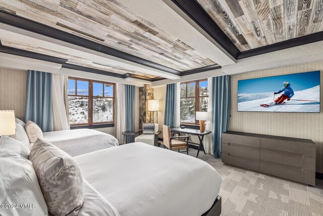 bedroom featuring multiple windows, light carpet, and wooden ceiling