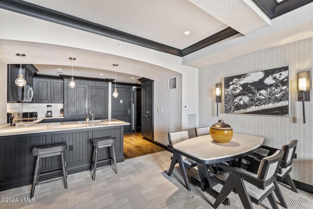 dining area featuring sink and ornamental molding