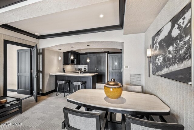 dining area featuring light carpet