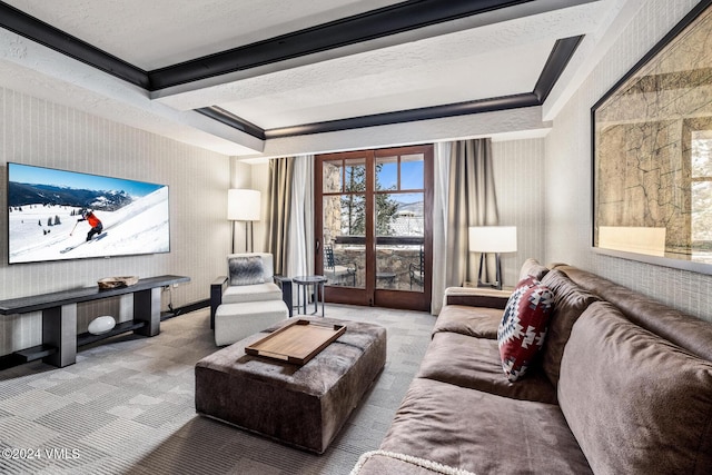 carpeted living room with crown molding, a textured ceiling, and a tray ceiling