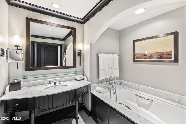 bathroom with vanity and a tub