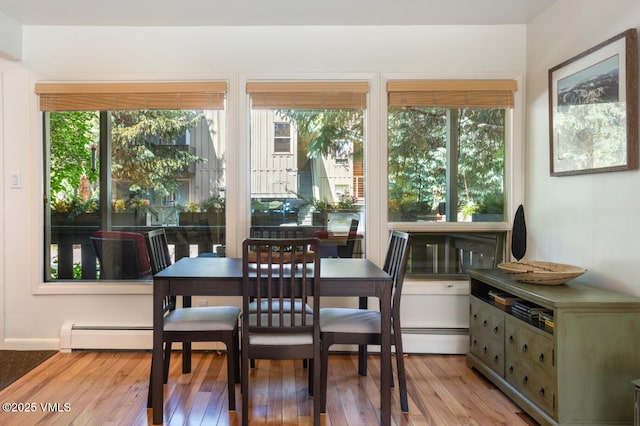 909 Red Sandstone Rd Unit B2, Vail, CO 81657 - dining space featuring hardwood / wood-style flooring, plenty of natural light, and a baseboard heating unit