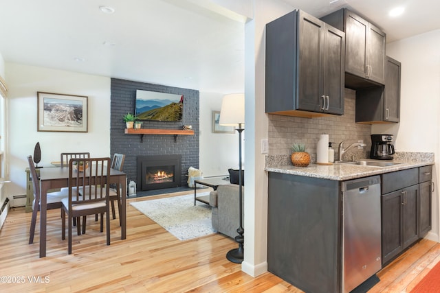 909 Red Sandstone Rd Unit B2, Vail, CO 81657 - kitchen featuring a sink, stainless steel dishwasher, light wood-type flooring, a brick fireplace, and recessed lighting