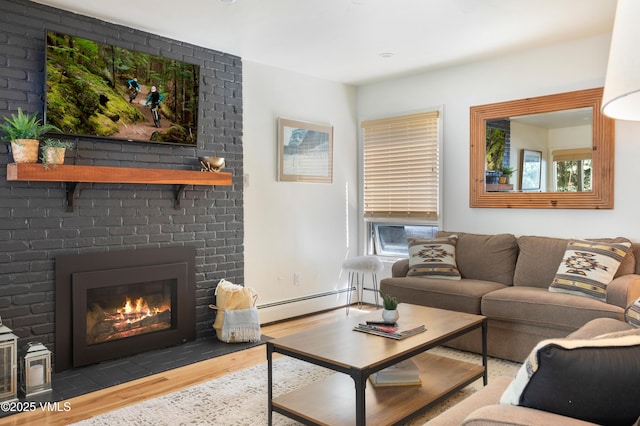 909 Red Sandstone Rd Unit B2, Vail, CO 81657 - living area featuring a baseboard radiator, wood finished floors, a fireplace, and plenty of natural light