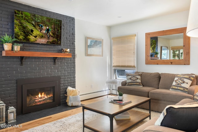 909 Red Sandstone Rd Unit B2, Vail, CO 81657 - living room featuring a baseboard heating unit, wood finished floors, a fireplace, and healthy amount of natural light