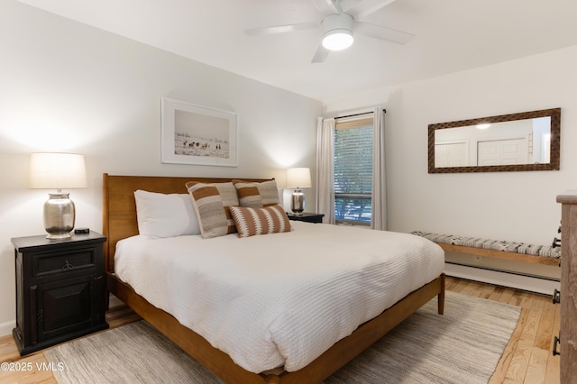 909 Red Sandstone Rd Unit B2, Vail, CO 81657 - bedroom with baseboard heating, light wood-type flooring, and a ceiling fan
