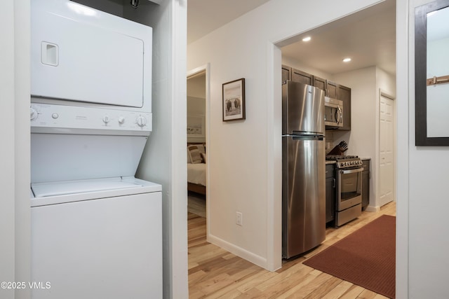 909 Red Sandstone Rd Unit B2, Vail, CO 81657 - laundry room with stacked washer / drying machine, light wood-type flooring, recessed lighting, and baseboards