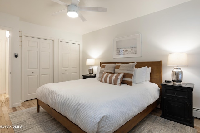 909 Red Sandstone Rd Unit B2, Vail, CO 81657 - bedroom featuring wood finished floors, multiple closets, ceiling fan, and a baseboard radiator