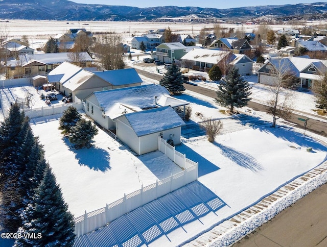 snowy aerial view with a mountain view