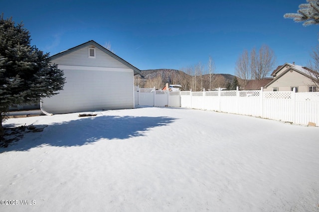 yard covered in snow with a mountain view