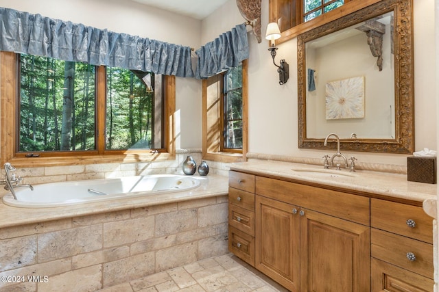 bathroom with a relaxing tiled tub and vanity