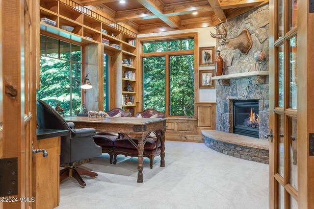 carpeted office featuring coffered ceiling, a fireplace, and beam ceiling