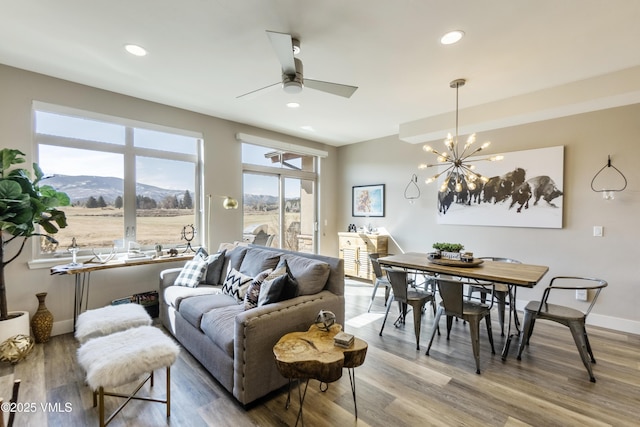 living area featuring recessed lighting, baseboards, and wood finished floors