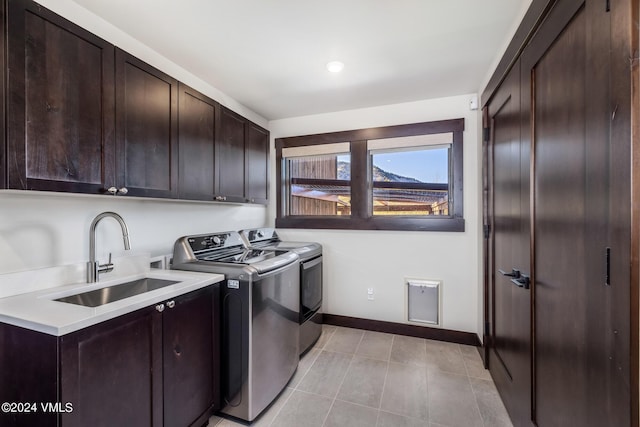 367 Hunters View Ln, Eagle, CO 81631 - laundry area with cabinet space, washing machine and clothes dryer, light tile patterned floors, and baseboards
