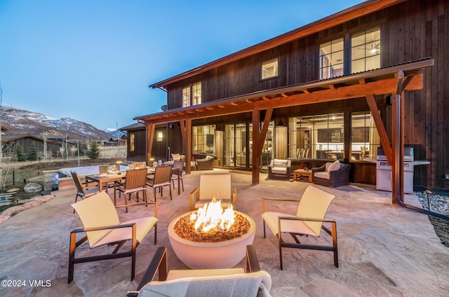 367 Hunters View Ln, Eagle, CO 81631 - view of patio / terrace with area for grilling, a mountain view, and an outdoor living space with a fire pit