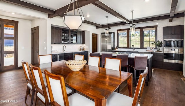 367 Hunters View Ln, Eagle, CO 81631 - dining area featuring dark wood-style flooring, beam ceiling, bar with sink, recessed lighting, and baseboards